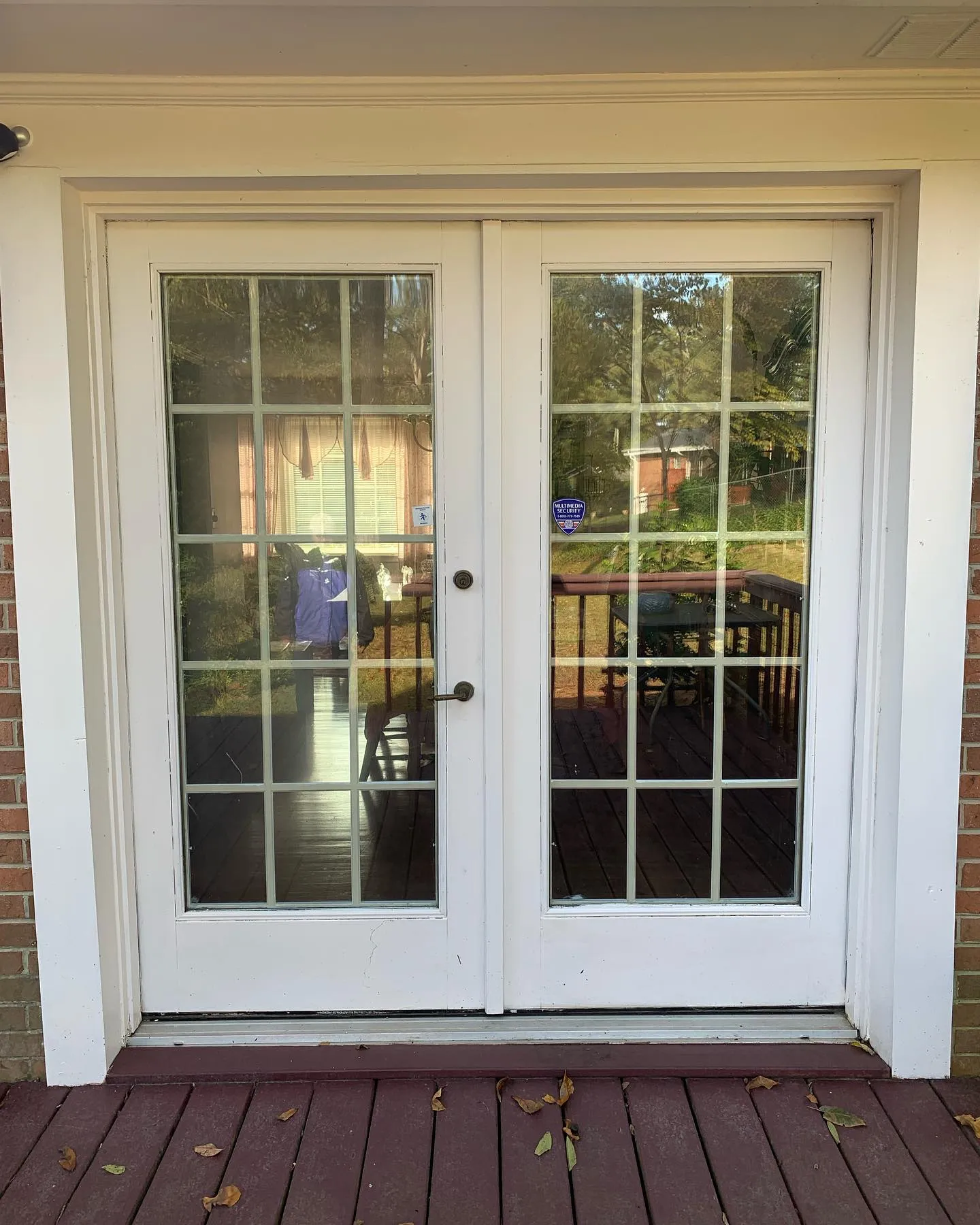 White French doors opening onto a timber deck
