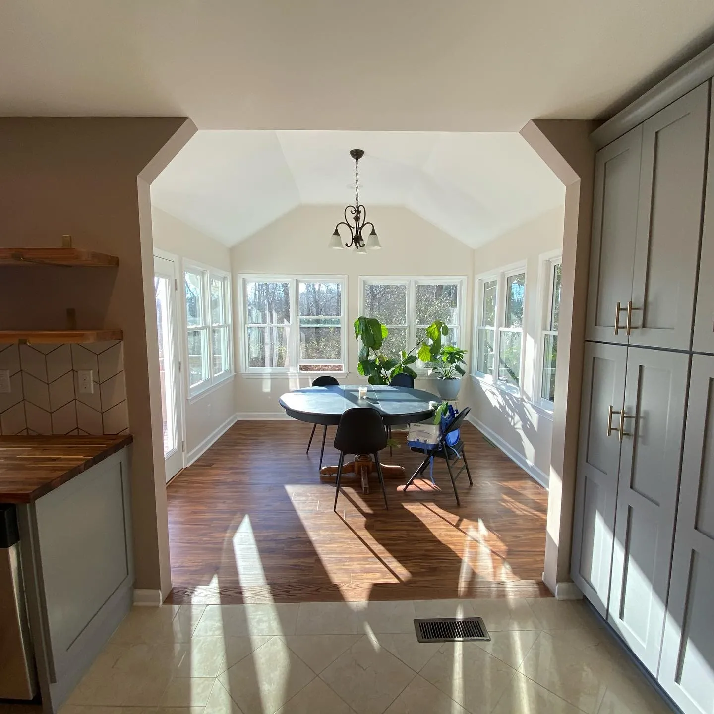 Hallway lined with full-height built-in cabinetry leading to an arched opening