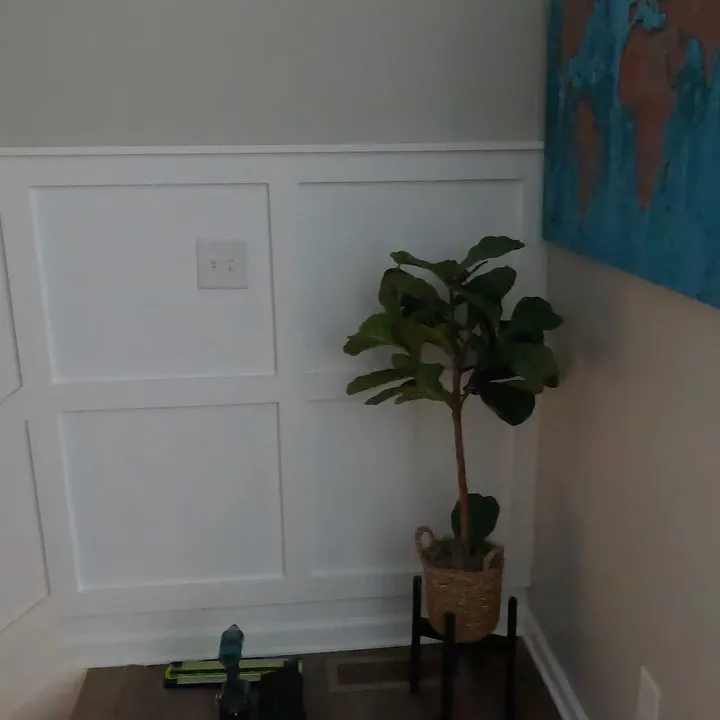 Board and batten wall panelling painted white in a living space